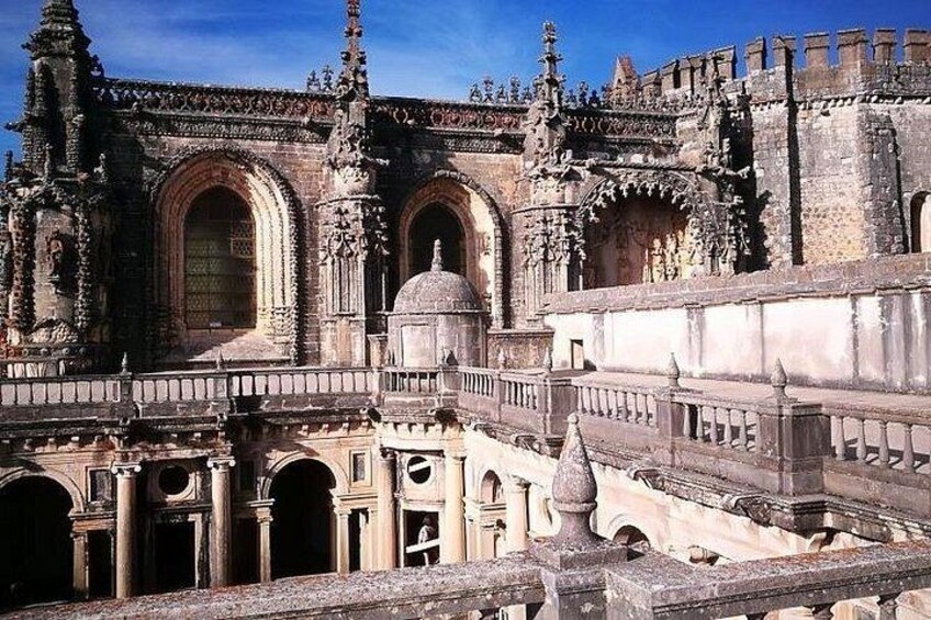 A historic building with ornate architecture, including arched doorways and detailed stonework. 3
