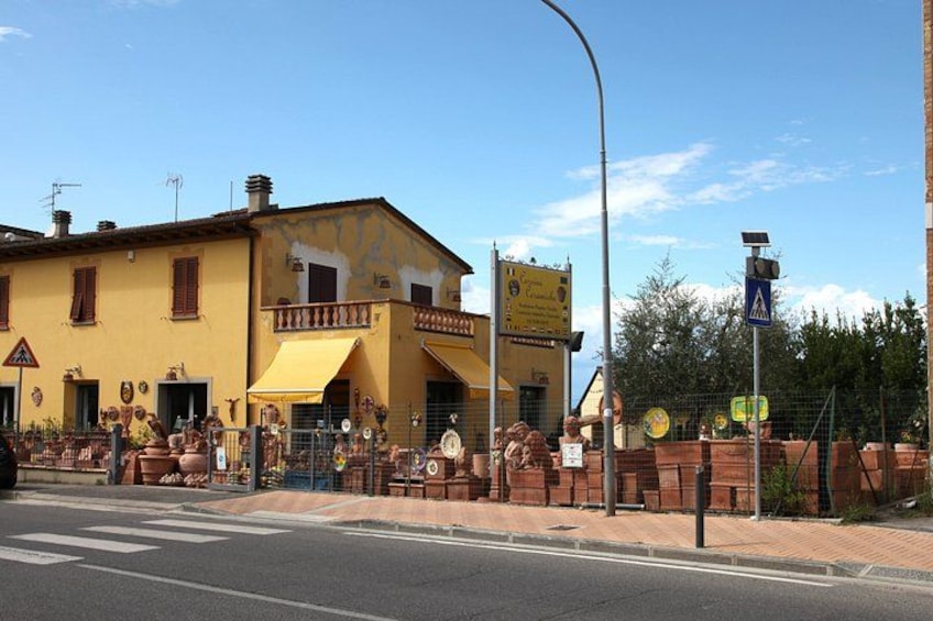 A yellow building with a balcony, a pedestrian crossing sign, and a solar panel on a pole. 2