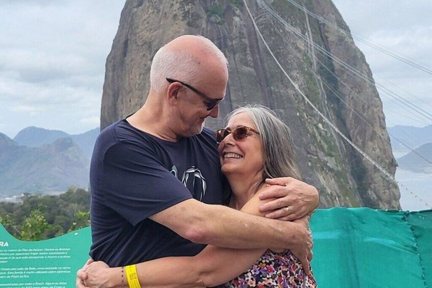 A couple embracing with a mountainous landscape in the background. 4