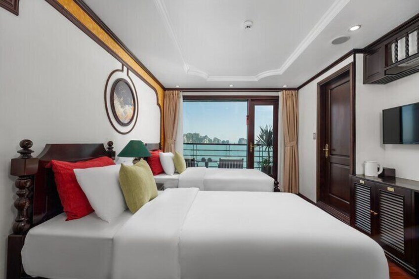 A hotel room with two beds, a TV, and a balcony with a view. 3