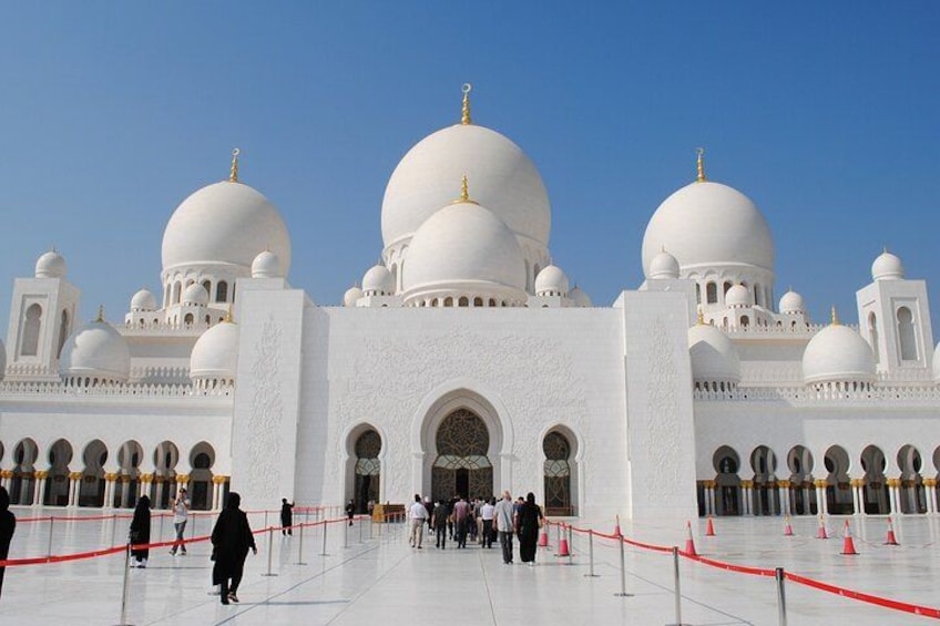 A large white building with multiple domes and arched windows. 1