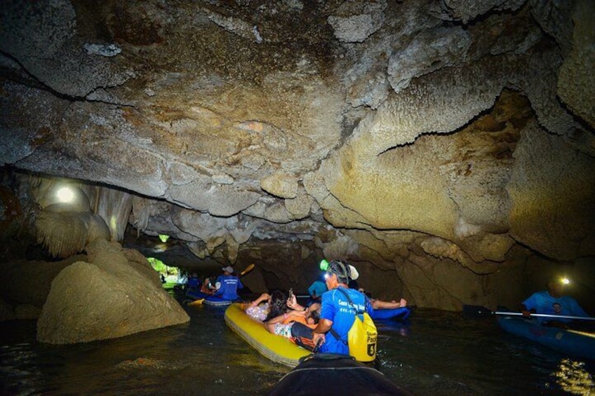 People kayaking in a cave. 4