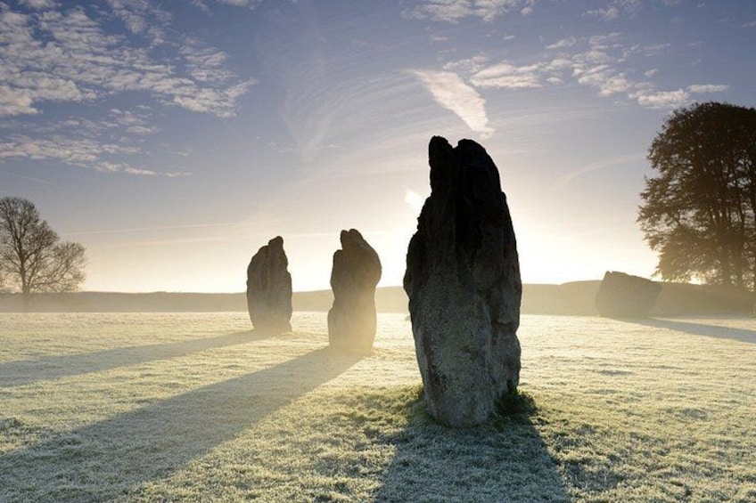 A landscape with three large rock formations in a field during daylight. 1