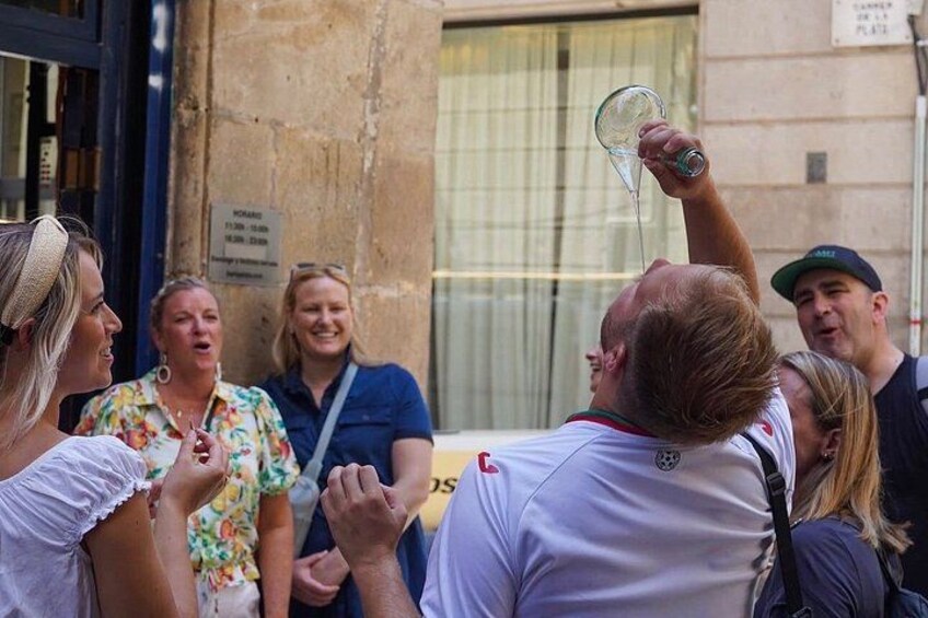 A group of people, one holding a glass. 1