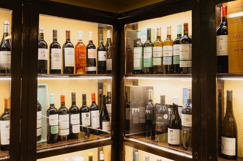 A wine cellar with multiple shelves of wine bottles. 3