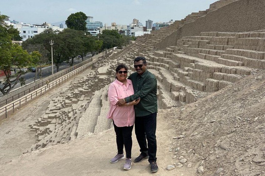 An archaeological site with ancient ruins and a modern cityscape in the background. 4