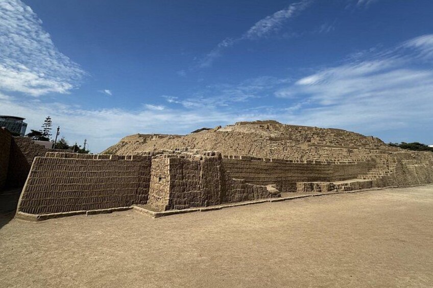 A large ancient stone structure with a flat top and a surrounding wall. 5