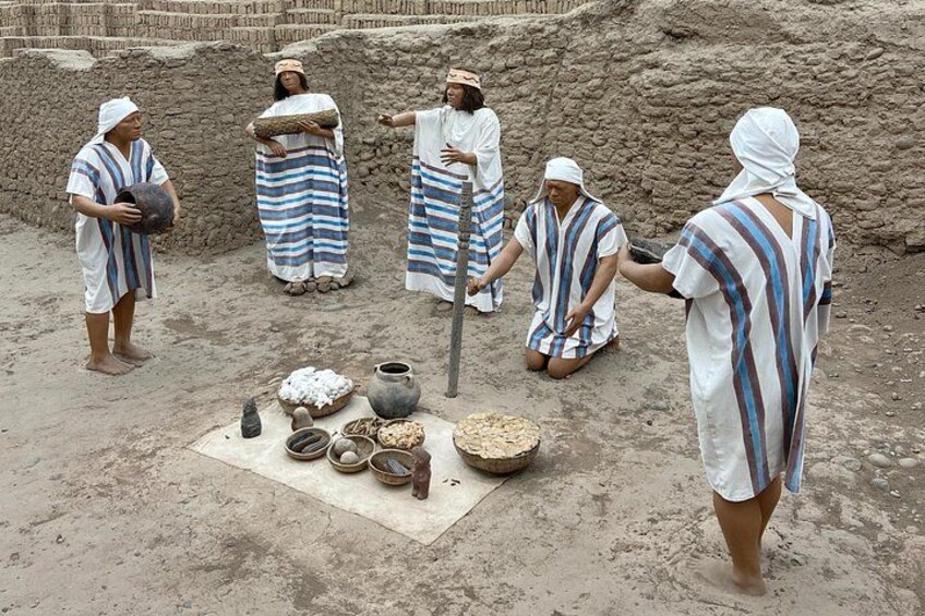 People in traditional attire performing a ritual with pottery and grains in an outdoor setting. 2