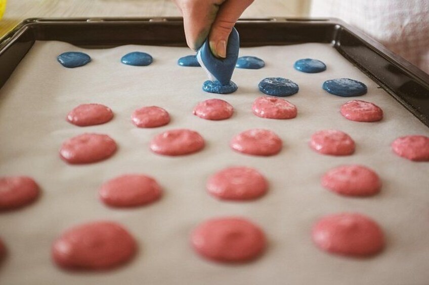 A baking sheet with pink and blue dough balls. 3