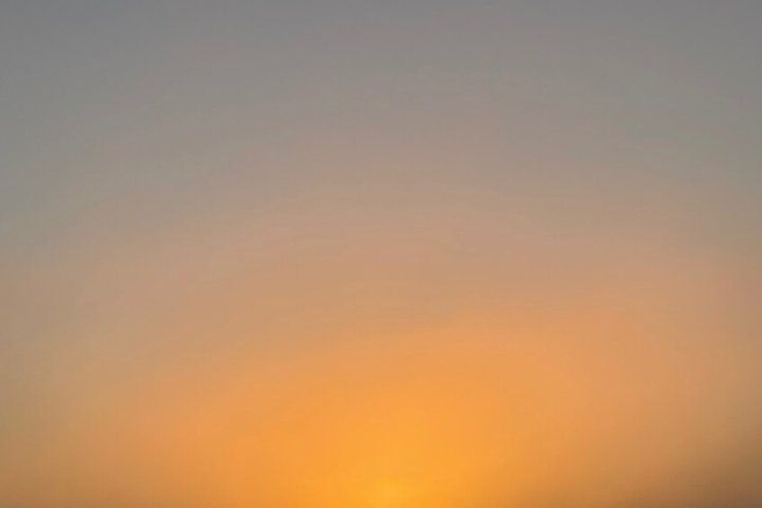 A gradient sky with a warm orange hue at the bottom. 3