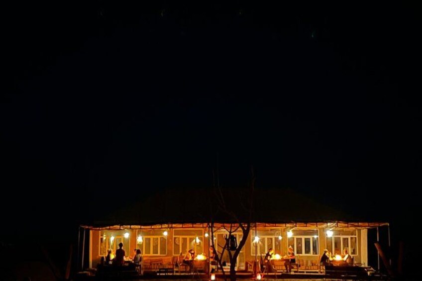 A building at night with lights on the exterior. 5