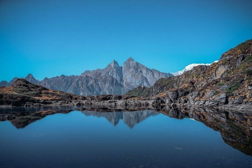 A mountain range with a clear reflection in a calm lake. 4