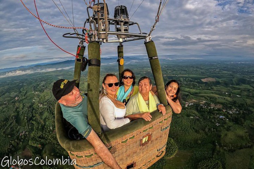 A hot air balloon with passengers over a landscape. 4
