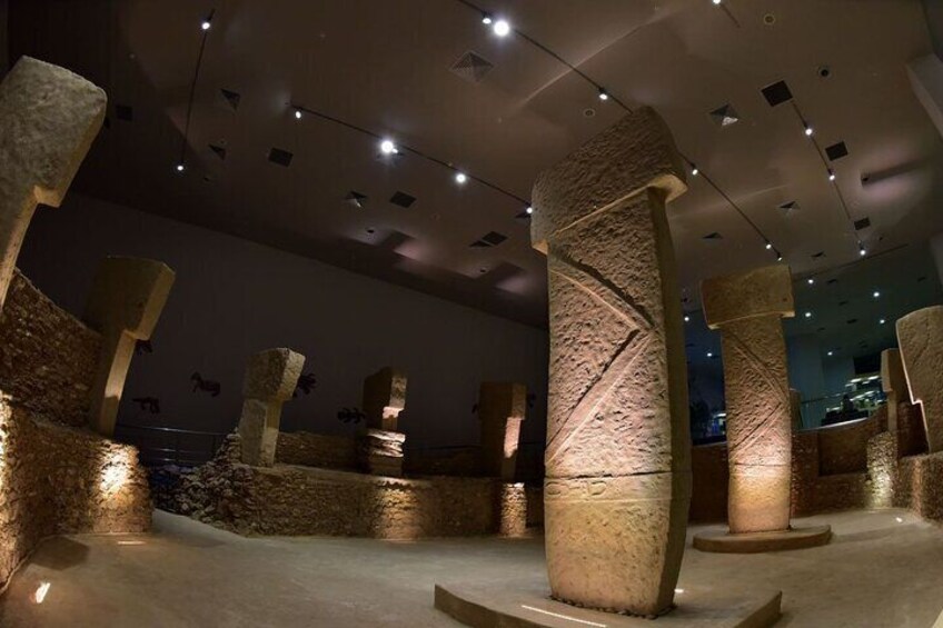 Ancient stone columns in a museum setting. 5