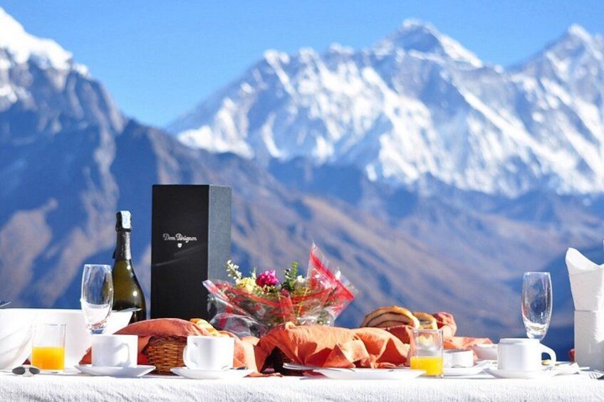 Colazione con una bottiglia, fiori e una scatola sullo sfondo di una montagna. 3