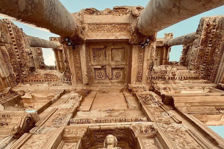 An ancient temple with intricate carvings and a central doorway. 4