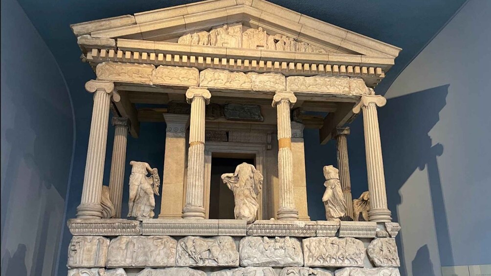 A classical building facade with columns and detailed carvings. 2