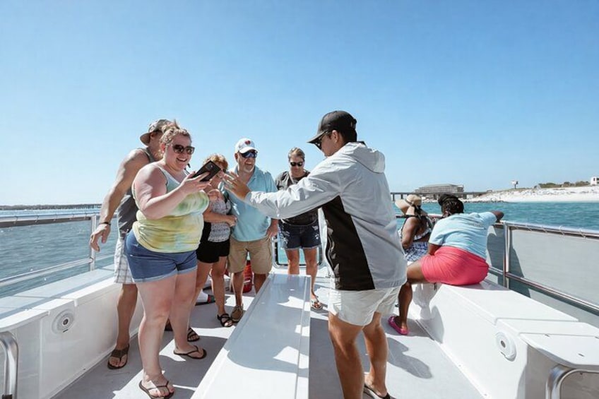 A group of people on a boat near a beach. 3