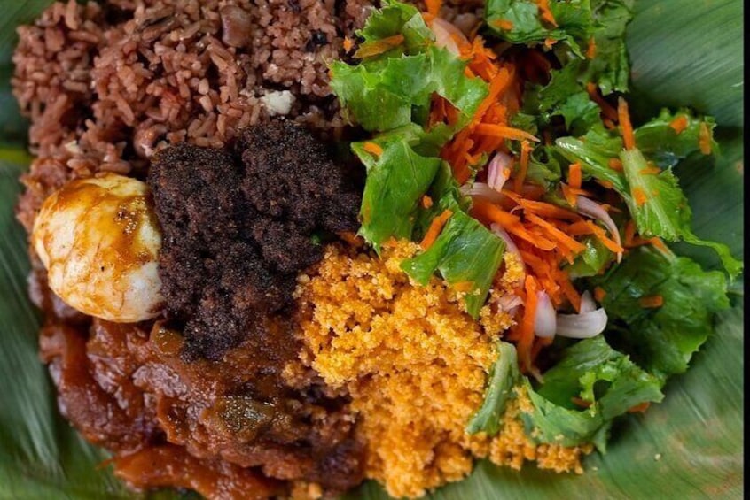 A plate of food with rice, a boiled egg, fried chicken, and a salad. 1
