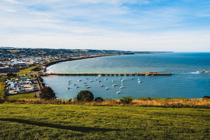 A coastal town with a marina, boats, and a clear view of the sea. 4