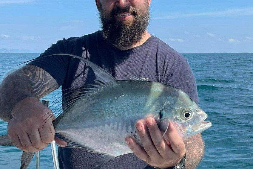 A person holding a fish. 5