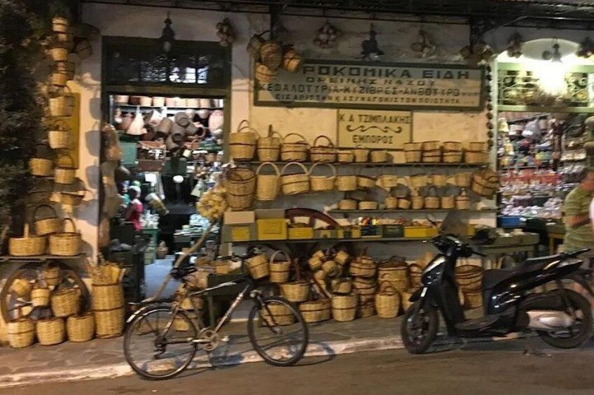 A market stall with baskets and a bicycle. 5