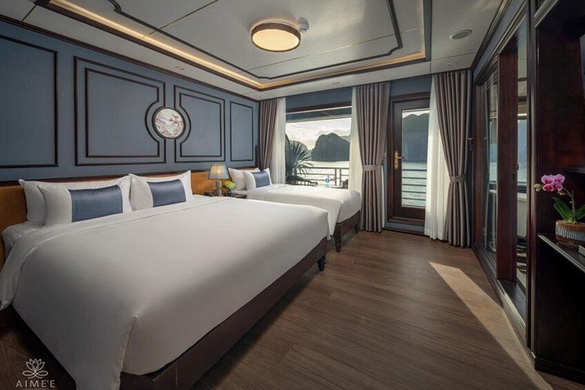 A luxurious bedroom with two large beds, a clock on the wall, and a view of the sea. 4