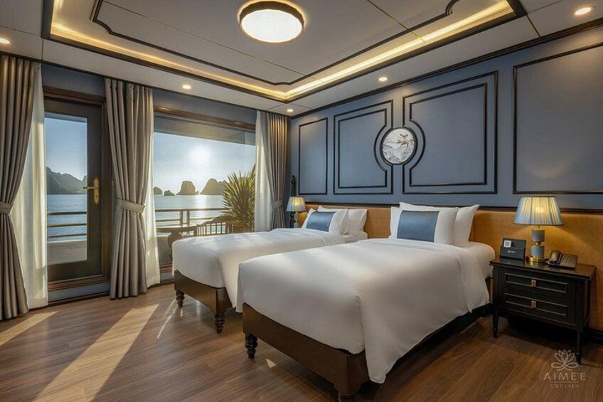 A luxurious bedroom with two beds, a large window overlooking a body of water, and a clock on the wall. 5