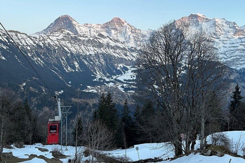 A snowy mountain landscape with a ski lift and a red cabin. 2