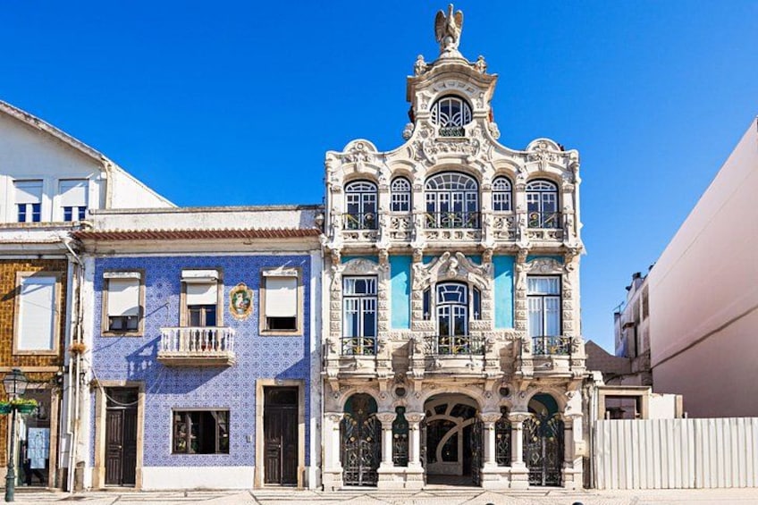 A historic building with ornate architecture, a blue-tiled facade, and a prominent balcony. 2