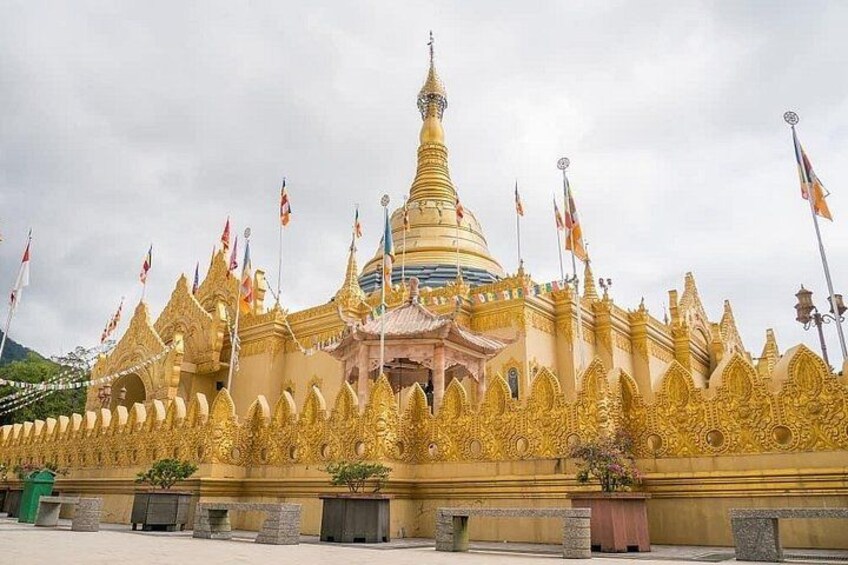 A golden temple with multiple spires and flags. 3