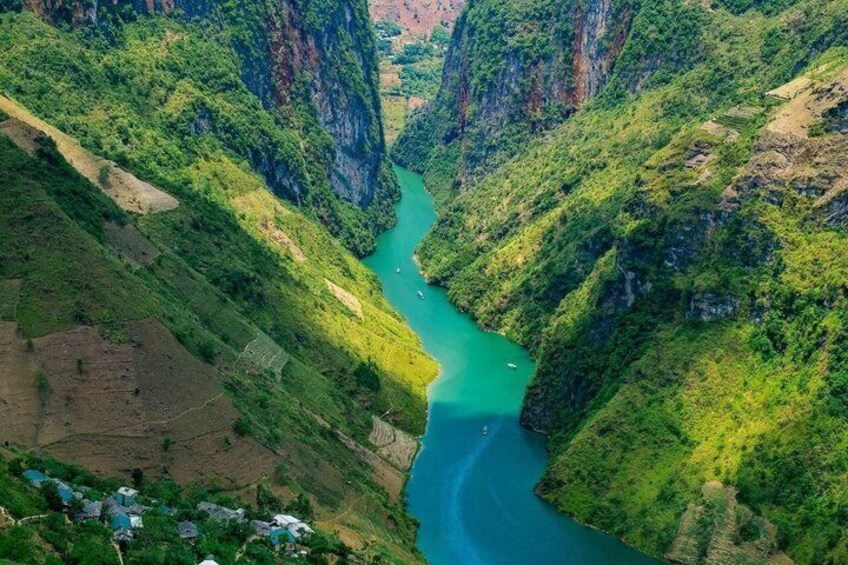 A river winding through a lush valley with steep cliffs. 3