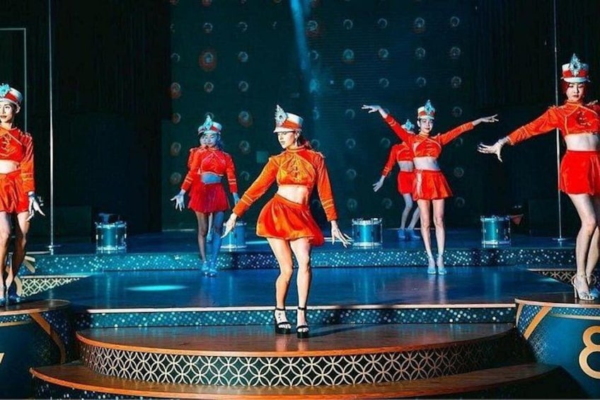 A stage with dancers in red costumes performing. 3