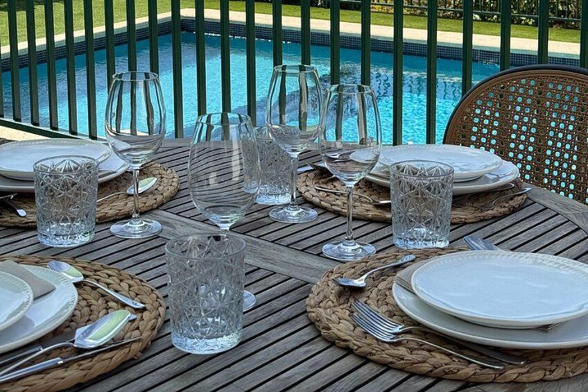 An inviting table set for a long and relaxed lunch with wine pairings. 5
