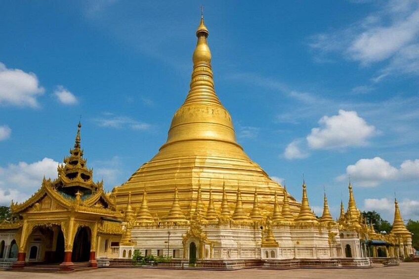 A large golden stupa with multiple smaller stupas in the background. 4