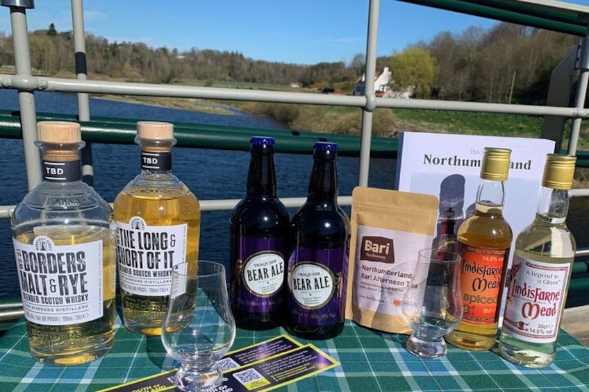 A table with various bottles of alcohol and a sign reading 'Northumberland'. 2