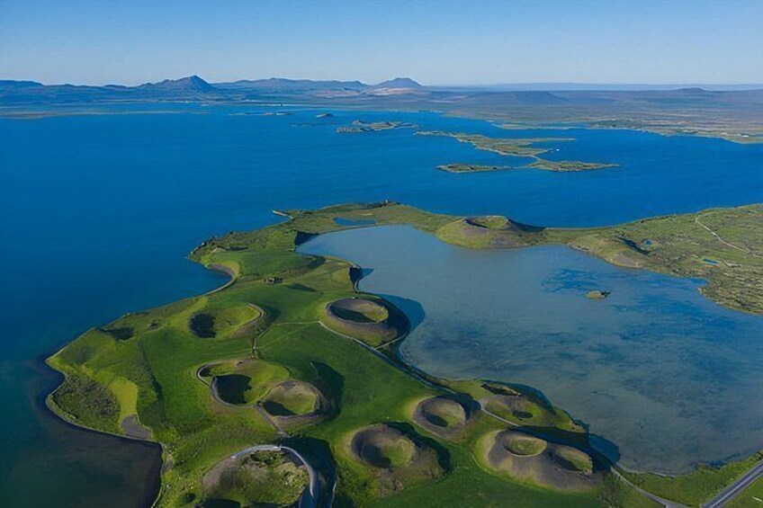 An aerial view of a coastal landscape with multiple islands and inlets, surrounded by a large body of water. 4