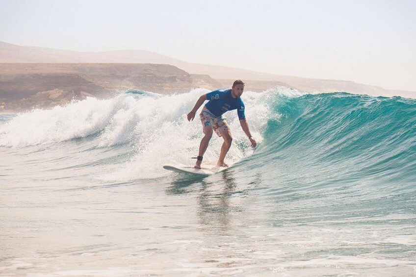 A surfer rides a clean, shoulder-high wave on the west coast of Fuerteventura. 1