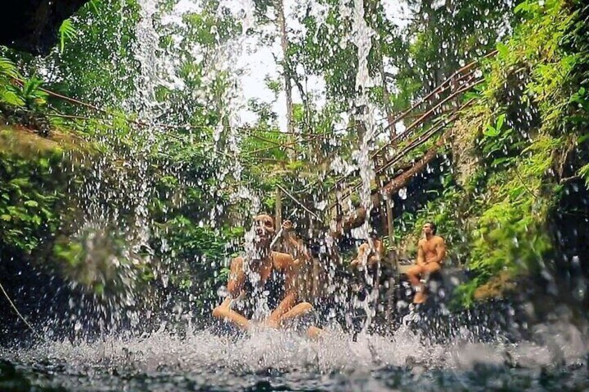 A waterfall with people sitting and standing around it. 3
