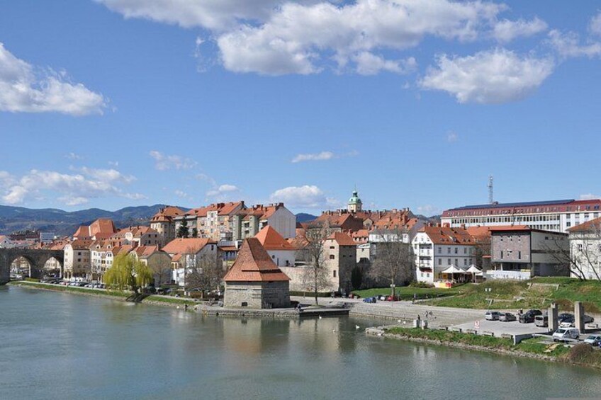 A river with buildings and a bridge in the background. 2