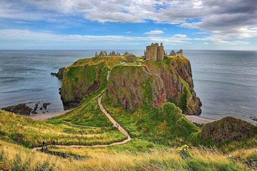 A coastal castle on a cliff with a path leading to it. 4