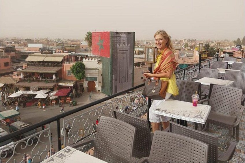 A balcony with outdoor seating overlooking a cityscape. 5