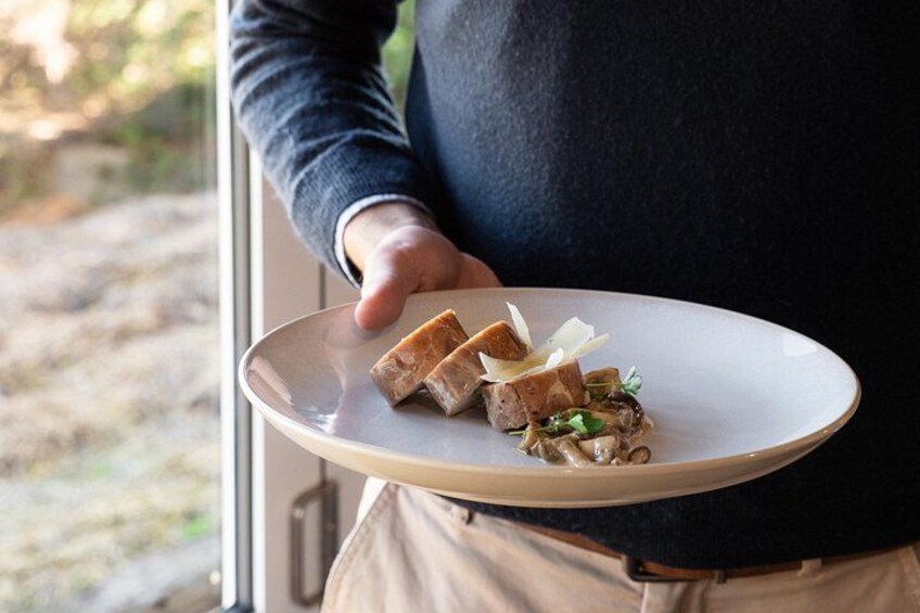 A person holding a plate with food. 3