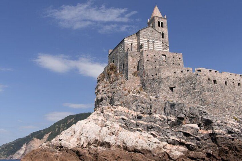 A medieval castle perched on a rocky cliff. 5