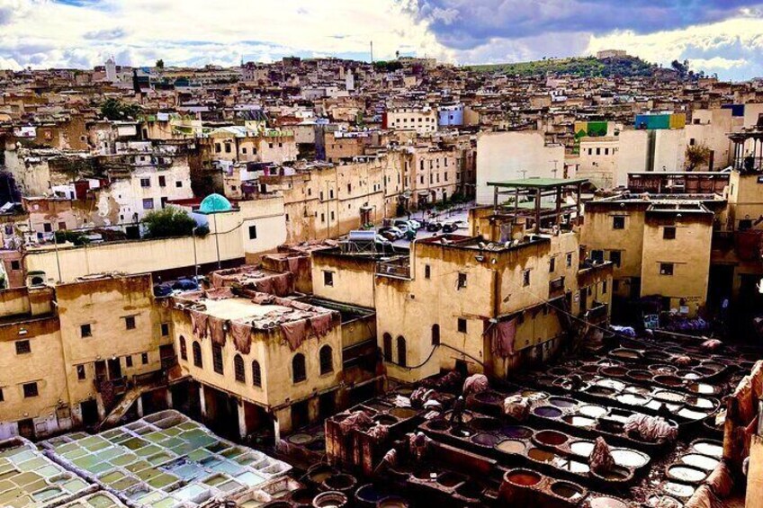 A densely packed urban area with old buildings and a tannery in the foreground. 3