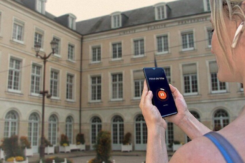 A person holding a smartphone with a hotel app interface. 4