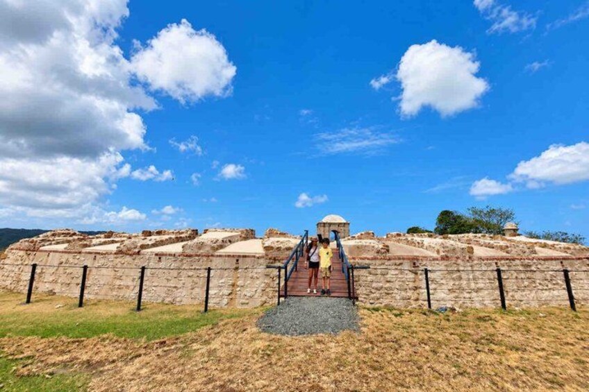 Ancient ruins with a dome structure, a staircase leading up to it, and a clear blue sky. 1