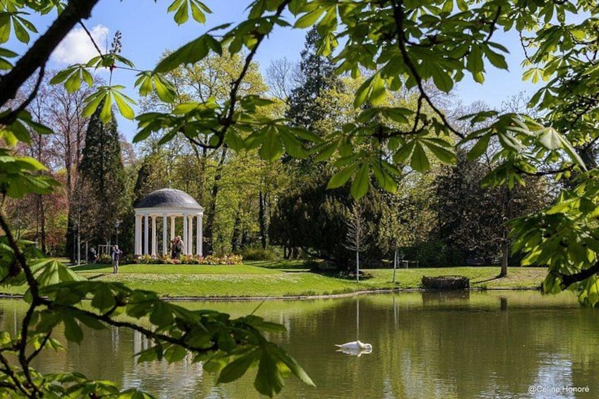 A gazebo, a pond, and trees in a park. 4