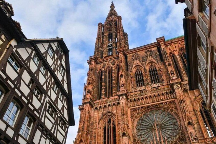 A historic cathedral with intricate architecture, including a large circular window and detailed stonework. 2
