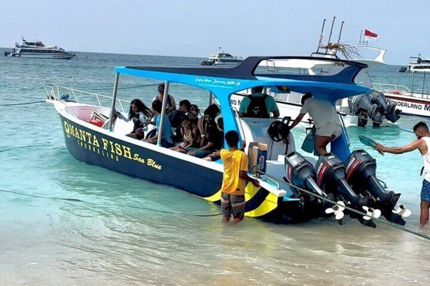 A boat named 'CANTATA FISH' with people boarding, surrounded by calm sea and other boats. 2
